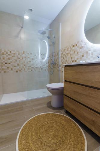 a bathroom with a shower and a toilet and a sink at Ap Turísticos Marea - Frente al Mar in Mojácar
