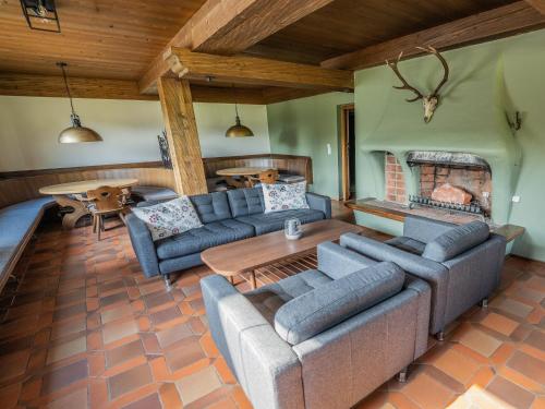 a living room with a couch and a table at Chalet in Angerberg near SkiWelt Slopes in Angerberg