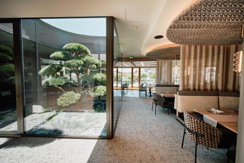 a restaurant with a table and chairs and a large window at Familotel Kindl in Neustift im Stubaital