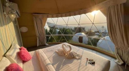a bedroom with a bed with two stuffed animals on it at Stratus Resort in Khao Kho
