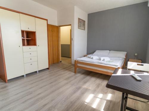 a bedroom with a bed and a dresser in it at Vila Melina Sarajevo in Bjelugovići