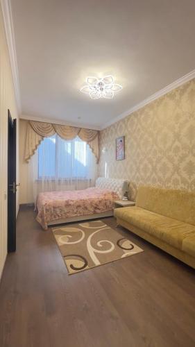 a bedroom with two beds and a couch and a rug at готель ДежаВю in Berdychiv