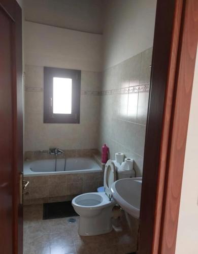a bathroom with a tub and a toilet and a sink at Panorama in Menídion