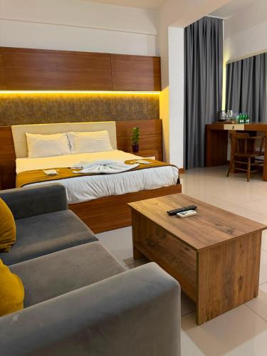 a hotel room with a bed and a coffee table at Nagas Premium Hotel in Yenişehir