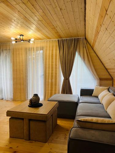 a living room with a couch and a table at Gerlik Cottage in Mestia