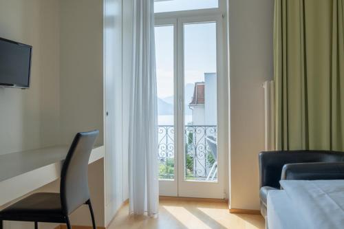 a hotel room with a view of a balcony at Seminar-Hotel Rigi am See in Weggis