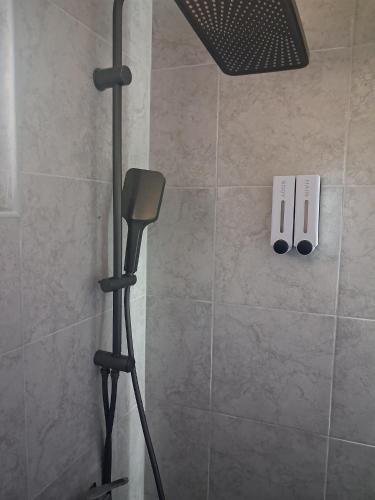 a shower with a shower head in a bathroom at Lajlas home in Orašac