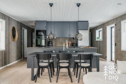 a kitchen with a table and chairs in it at The Black Bear Lodge in Tällberg