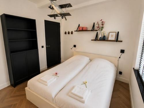 a bedroom with a bed with two pillows on it at Cozy apartment in authentic farmhouse in Gouda