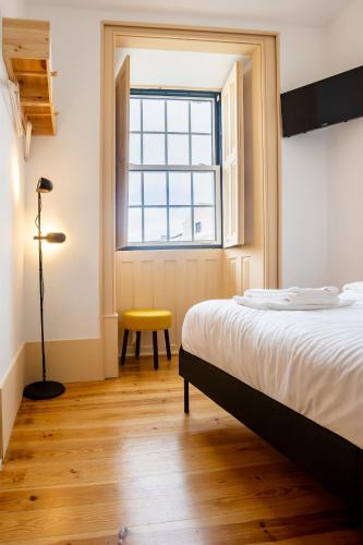 a bedroom with a bed and a window at Sleep in Centre - Old Town in Aveiro