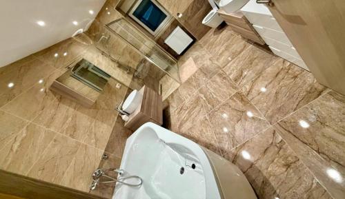 an overhead view of a bathroom with a toilet and a tub at Apartmani LU&LO in Delnice