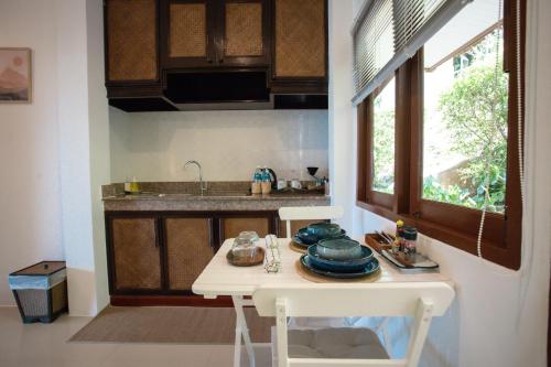 a kitchen with a table with dishes on it at Baan Phuvara Retreat - Romantic Jacuzzi Mountain View Villas in Ao Nang Beach
