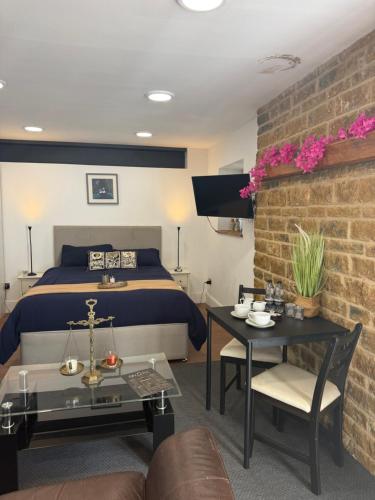 a bedroom with a bed and a brick wall at Rutland Point in Uppingham