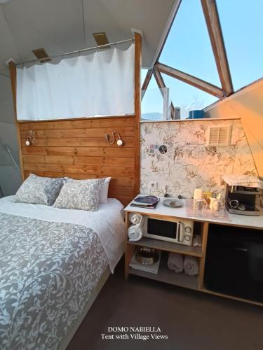 a bedroom with a bed and a tv in a room at Mirador de Pideago in Bolea