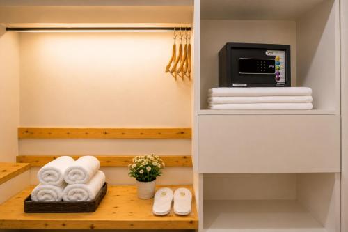 a walk in closet with towels and a microwave at Sparrow Elements Boutique 2 min walk To Mg Marg in Gangtok