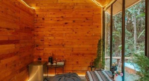 a room with a wooden wall and a window at LOUVREFER in Ban Pa Pae