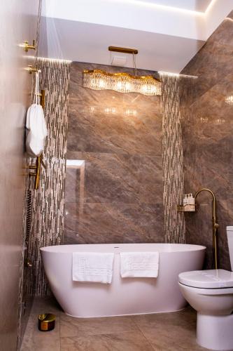 a bathroom with a bath tub and a toilet at Sungora sun&ski resort in Slavske