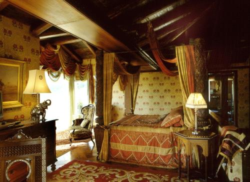 a bedroom with a canopy bed and a window at Villa Althea in Mango