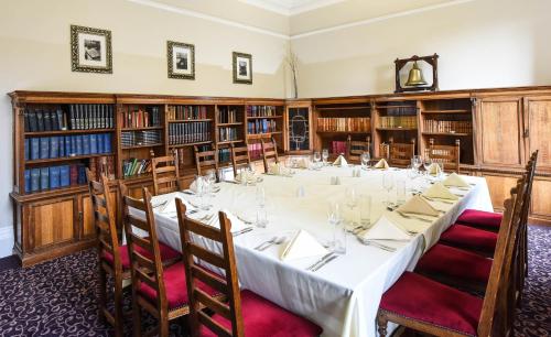 a long table in a room with bookshelves at Halifax Hall in Sheffield