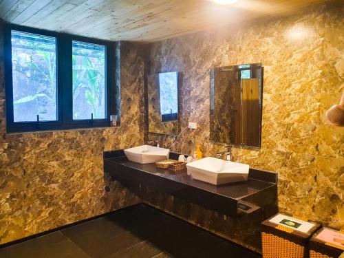 a bathroom with two sinks and a mirror at Phủ Homestay Sapa in Sapa