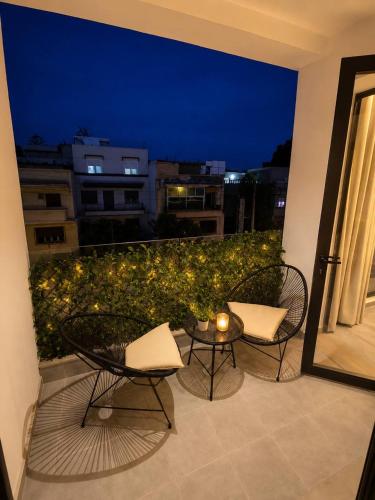 two chairs and a table on a balcony at night at Elegant Studio in Casablanca in Casablanca