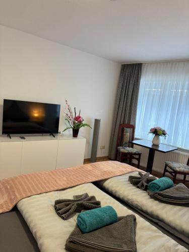 a hotel room with two beds with towels on them at Elbstone 1 in Wittenberge