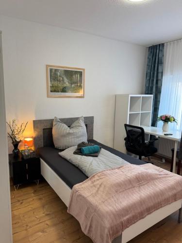 a bedroom with a bed and a desk with a chair at Elbstone 1 in Wittenberge