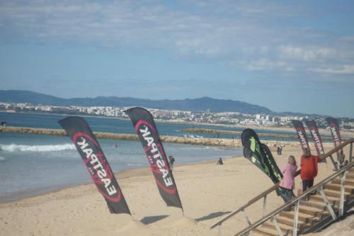 a group of signs in the sand on a beach at Casa Mar in Costa da Caparica
