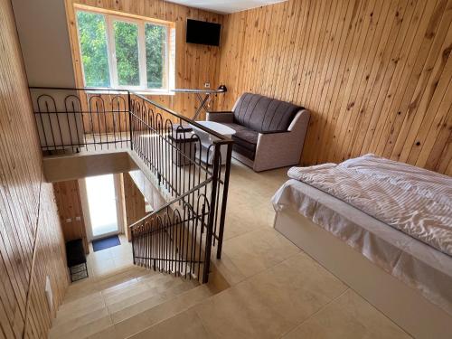 a room with a bed and a couch and a chair at Апартаменти Атаман in Zhovtnevoye