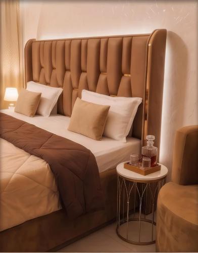 a bedroom with a large bed with a large headboard at Peaceful Studio with Kitchen in New Delhi