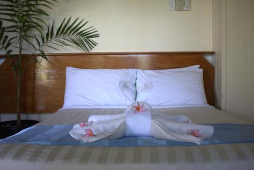 a bedroom with a bed with towels on it at Rapopo Plantation Resort in Kokopo