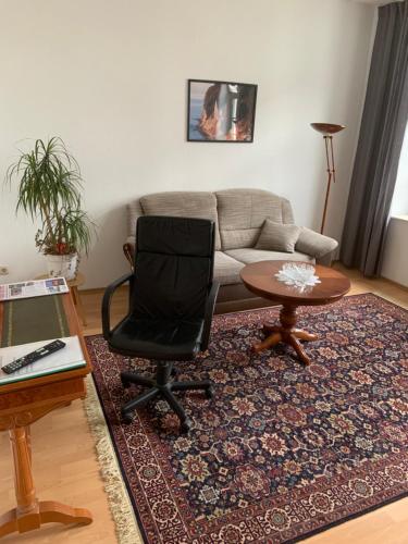 a living room with a couch and a chair and a table at Altstadt Ferienwohnung in Wismar