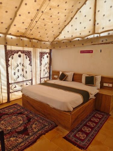 a bedroom with a bed in a tent at Marwar Desert Camp Sam Jaisalmer in Sām