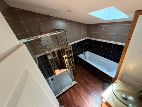 an overhead view of a bathroom with a shower and a tub at La Marcillande in Saint-Cyprien