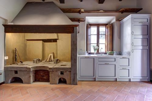 a kitchen with a large table in the middle at Villa Le Barone in Panzano