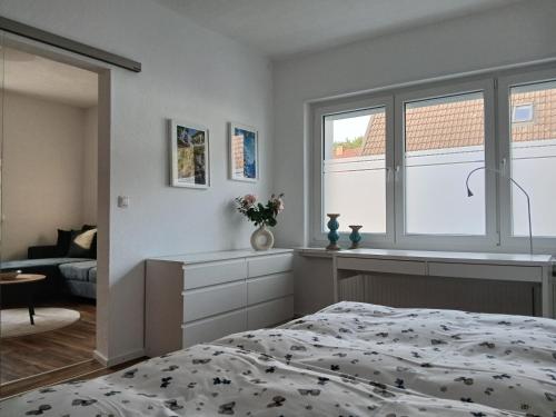 a bedroom with a bed and a window at Ferien-Appartement Schröer in Nordwalde
