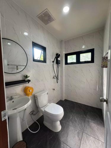a bathroom with a white toilet and a sink at ธนาภา 