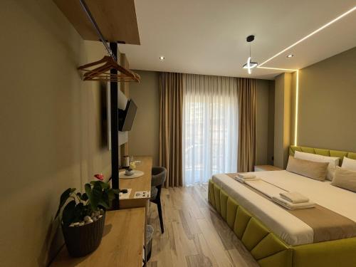 a hotel room with a bed and a couch at Mont Blanc Hotel in Peshkopi