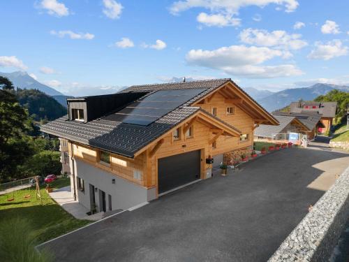 a house with solar panels on the roof at Le Petit Lu in Leysin