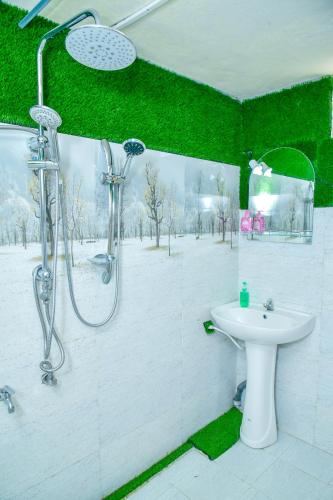 a bathroom with a shower and a sink at Ella Black Bridge Grand View Cottage Sri Lanka in Ella