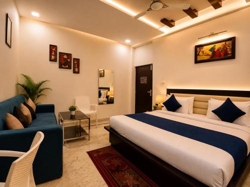 a hotel room with a bed and a couch at Hotel Aaradhya Residency in Agra