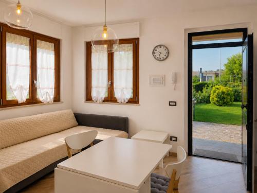 a living room with a couch and a table at Smart Suite at Villa Anna - Bike Friendly in Buonconvento