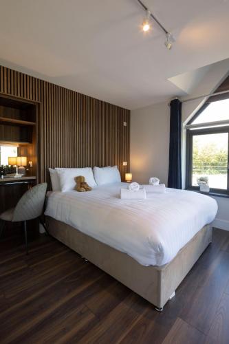 a bedroom with a large bed with a dog sitting on it at Dingle Lispole Garden Suite 10 B in Lispole
