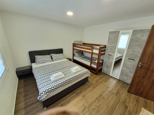 a small bedroom with a bed and a mirror at Komarnica Willage home in Šavnik
