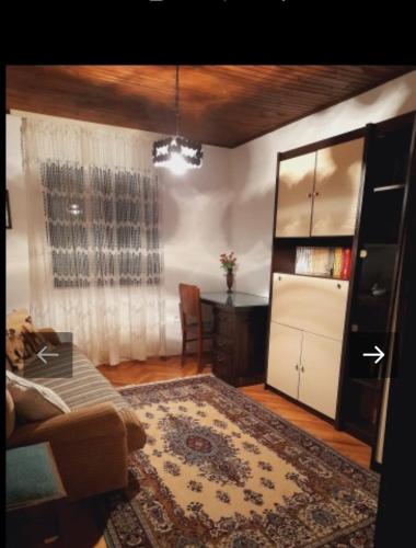 a living room with a couch and a table at Vikendica Katarina in Ovčar Banja