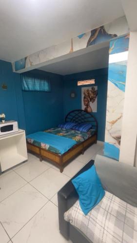 a bedroom with two bunk beds and a couch at Studio F cosy in Cayenne