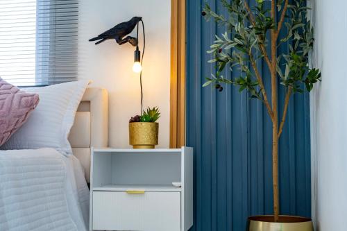 a bedroom with a bed and a nightstand with a plant at Bselifestyle in Green Island