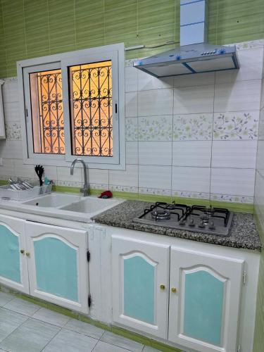 a kitchen with a stove top and a sink at Le Minaret in Kairouan