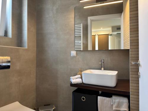 a bathroom with a sink and a mirror at Olympus Stone Lodge in Litochoro