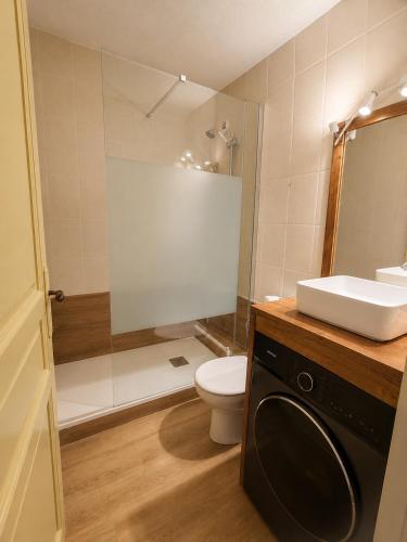 a bathroom with a toilet and a sink and a shower at Montana Family Nature in Enveitg